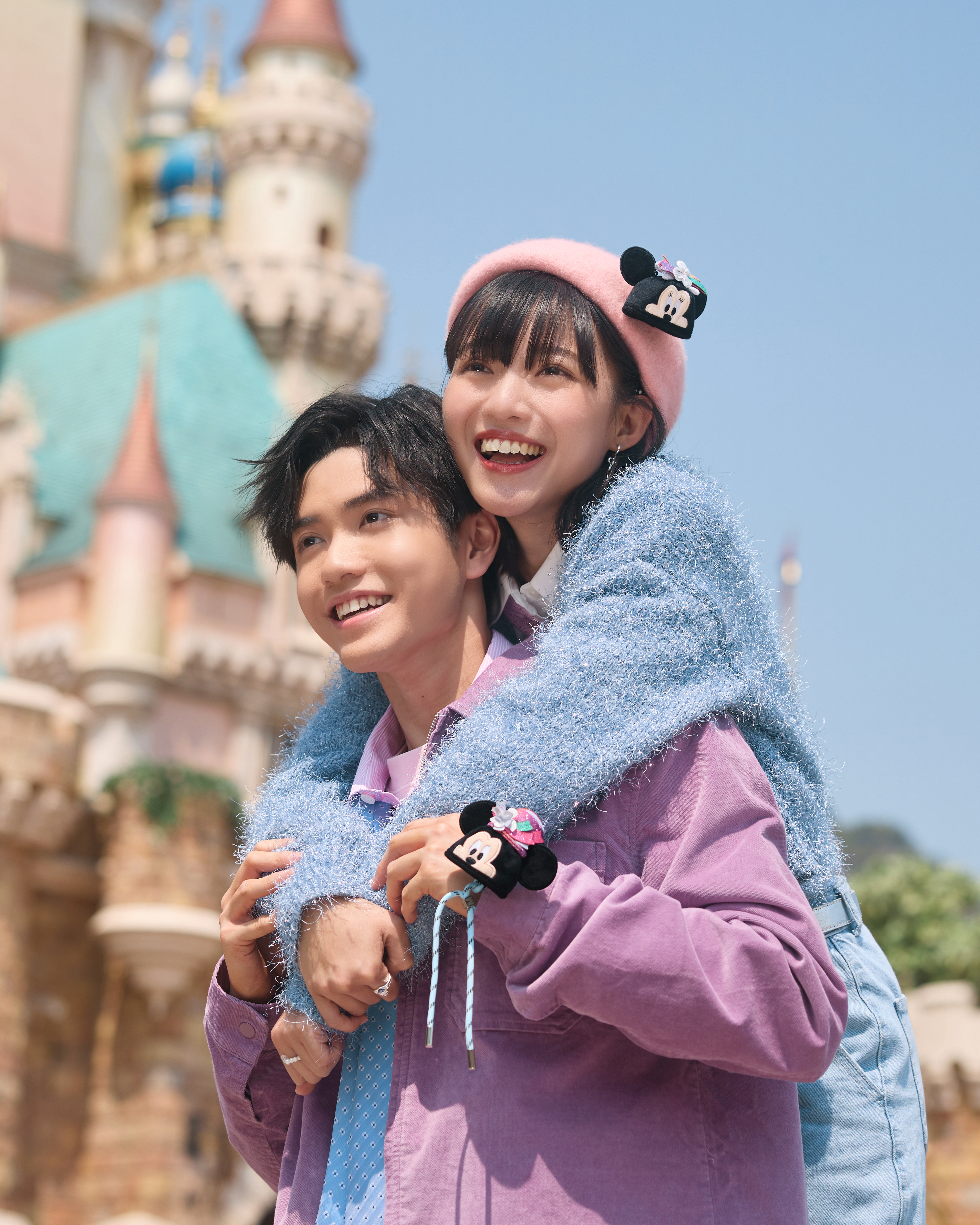 Visitors enjoying the view of Sleeping Beauty Castle at Disneyland Hong Kong.