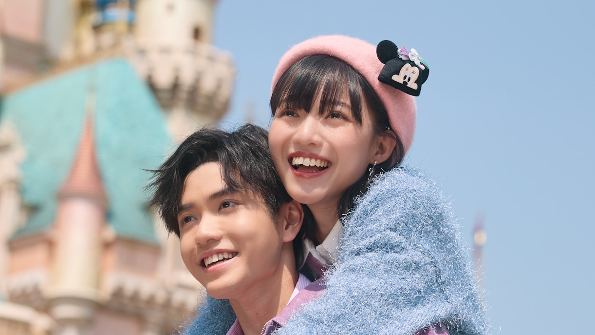 Visitors enjoying the view of Sleeping Beauty Castle at Disneyland Hong Kong.