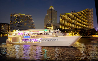 Chao Phraya Princess cruise at night with city skyline, Bangkok.