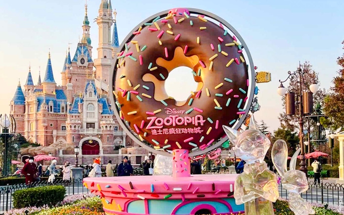 Zootopia-themed donut sculpture in front of a castle at a Disney park.
