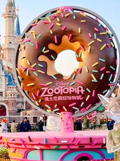 Zootopia-themed donut sculpture in front of a castle at a Disney park.