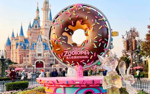 Zootopia-themed donut sculpture in front of a castle at a Disney park.
