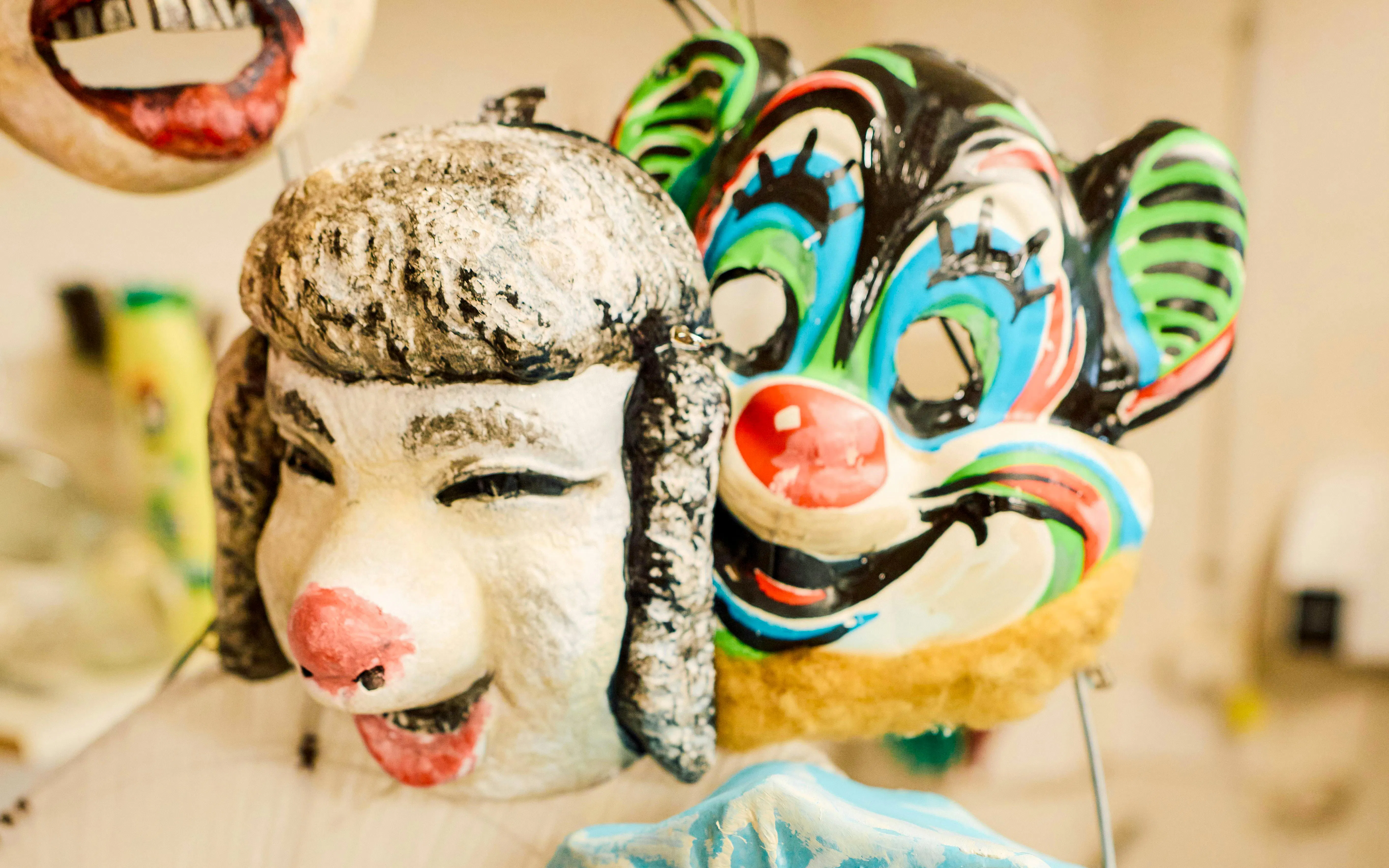 Colorful theatrical masks used in La Boheme performance.