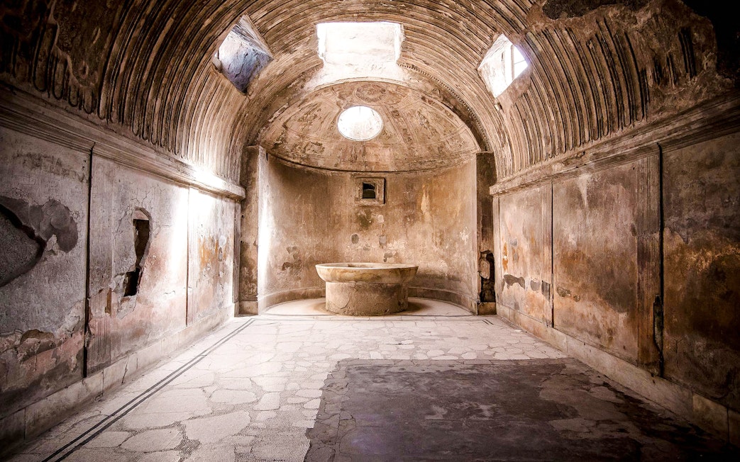 Ancient bathhouse interior at Pompeii ruins, Italy.