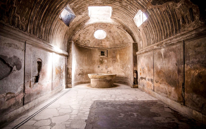 Ancient bathhouse interior at Pompeii ruins, Italy.