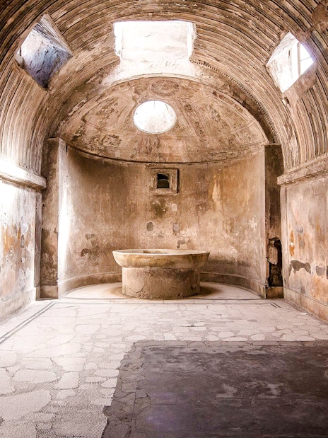 Ancient bathhouse interior at Pompeii ruins, Italy.