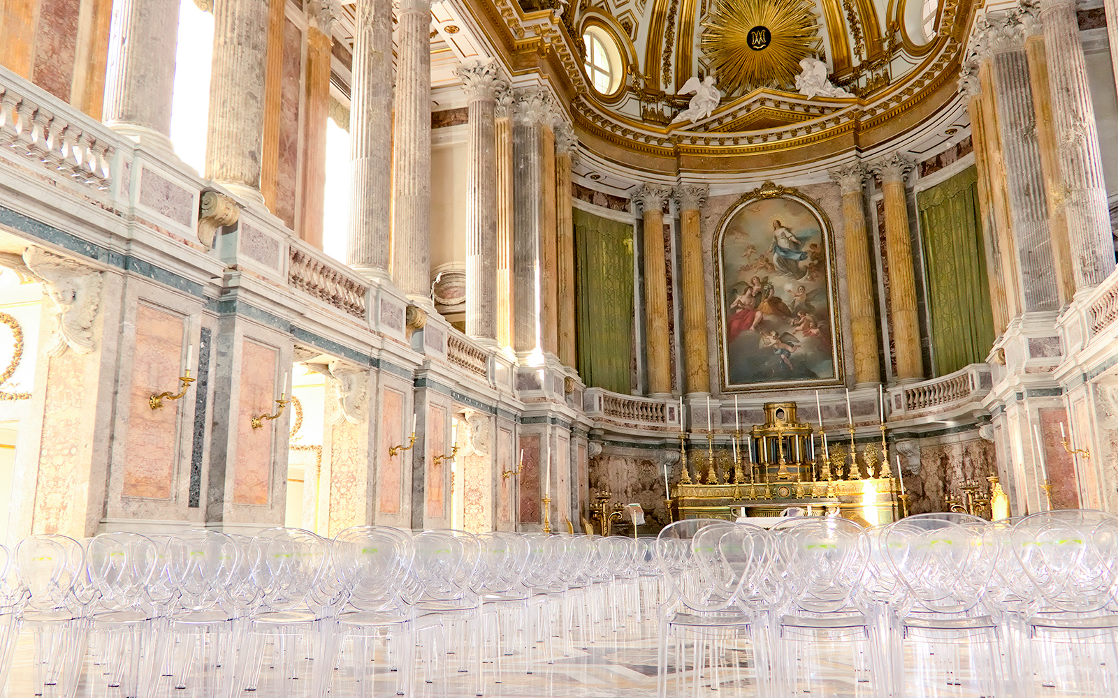 Royal Palace interior with ornate columns and grand altar, featuring clear seating for visitors.