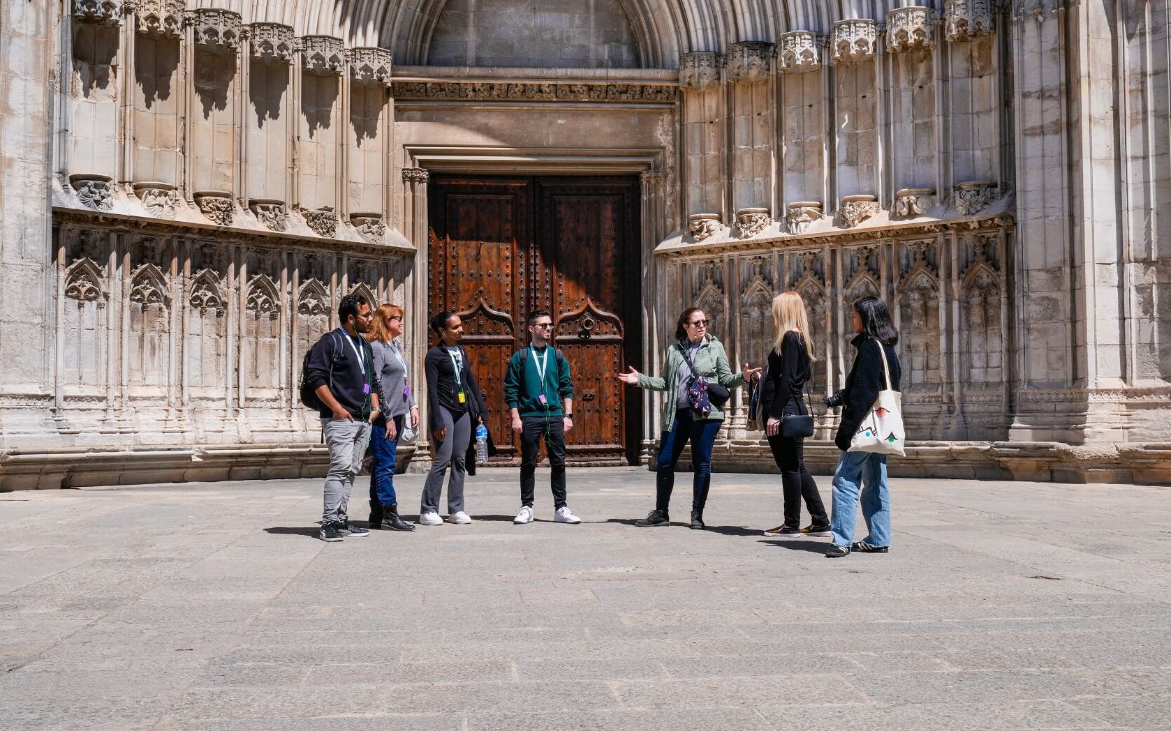 Tour group in front of Girona Cathedral, exploring medieval Old Town, Girona, Spain.