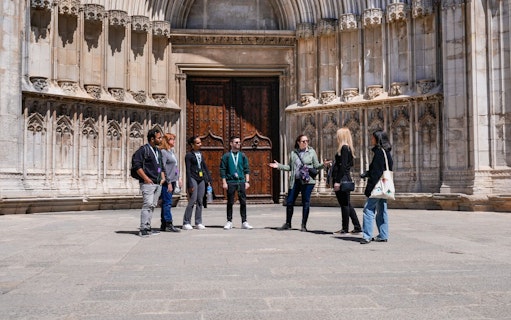 Tour group in front of Girona Cathedral, exploring medieval Old Town, Girona, Spain.
