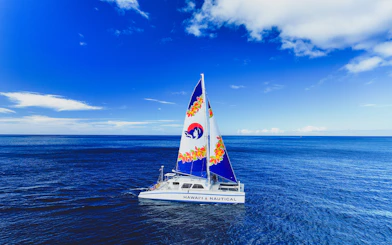 Catamaran sailing in clear blue waters of West Oahu, Hawaii.