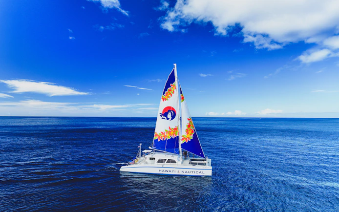 Catamaran sailing in clear blue waters of West Oahu, Hawaii.