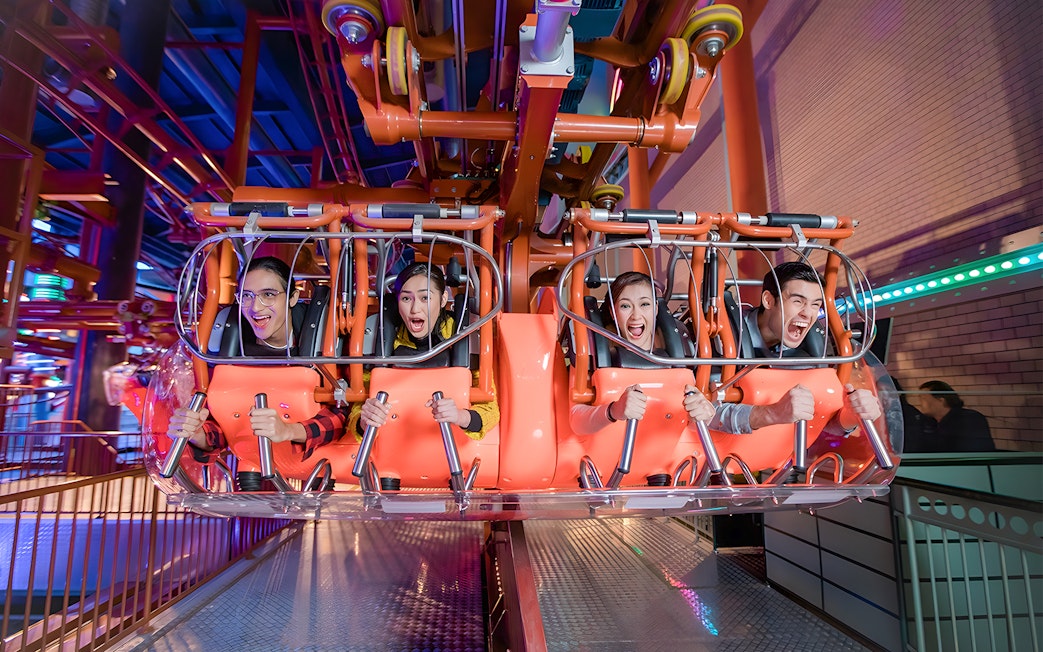 Visitors enjoying a thrilling ride at Genting Skytropolis Indoor Theme Park.