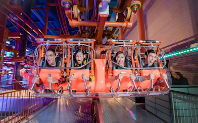 Visitors enjoying a thrilling ride at Genting Skytropolis Indoor Theme Park.