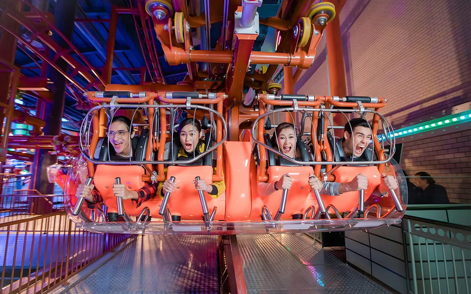 Visitors enjoying a thrilling ride at Genting Skytropolis Indoor Theme Park.