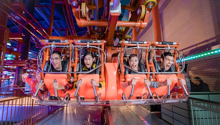Visitors enjoying a thrilling ride at Genting Skytropolis Indoor Theme Park.
