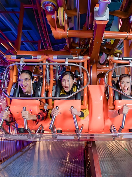 Visitors enjoying a thrilling ride at Genting Skytropolis Indoor Theme Park.