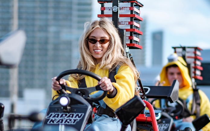 People driving go-karts in Shibuya during a 2-hour street experience.