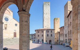 Torre Grossa in San Gimignano's historic square with medieval architecture.