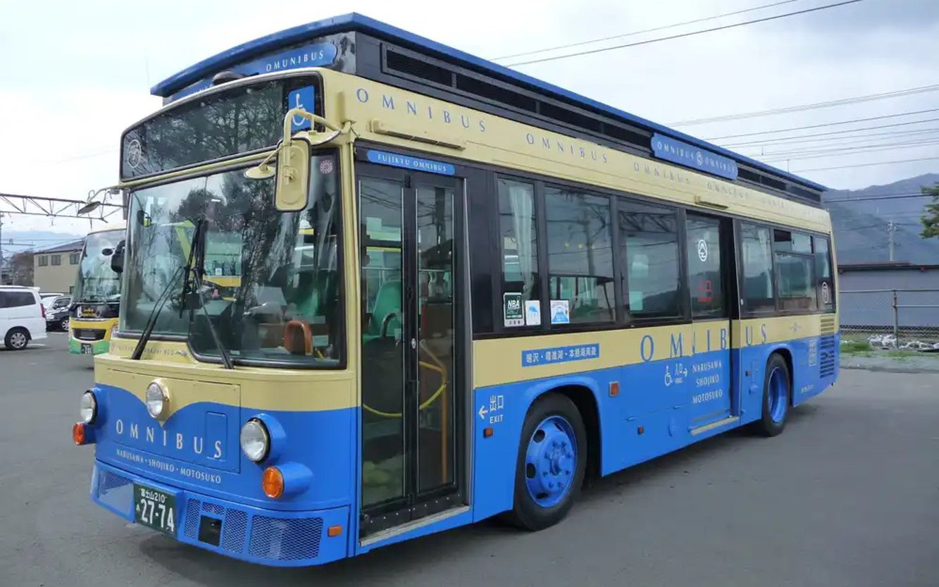 Blue and beige tour bus for Kawaguchiko sight-boat and Mt. Fuji Panorama Ropeway with 2-day pass.