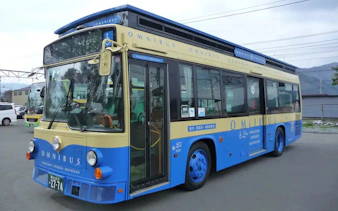 Blue and beige tour bus for Kawaguchiko sight-boat and Mt. Fuji Panorama Ropeway with 2-day pass.