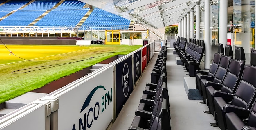 San Siro Stadium seating area with view of the field and stands in Milan, Italy.