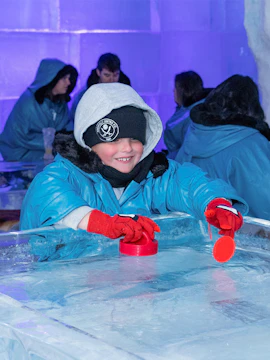 Child playing ice hockey game at IceBar Gold Coast.