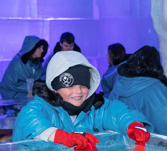 Child playing ice hockey game at IceBar Gold Coast.