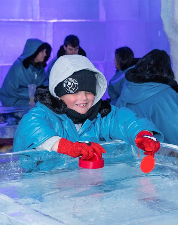 Child playing ice hockey game at IceBar Gold Coast.