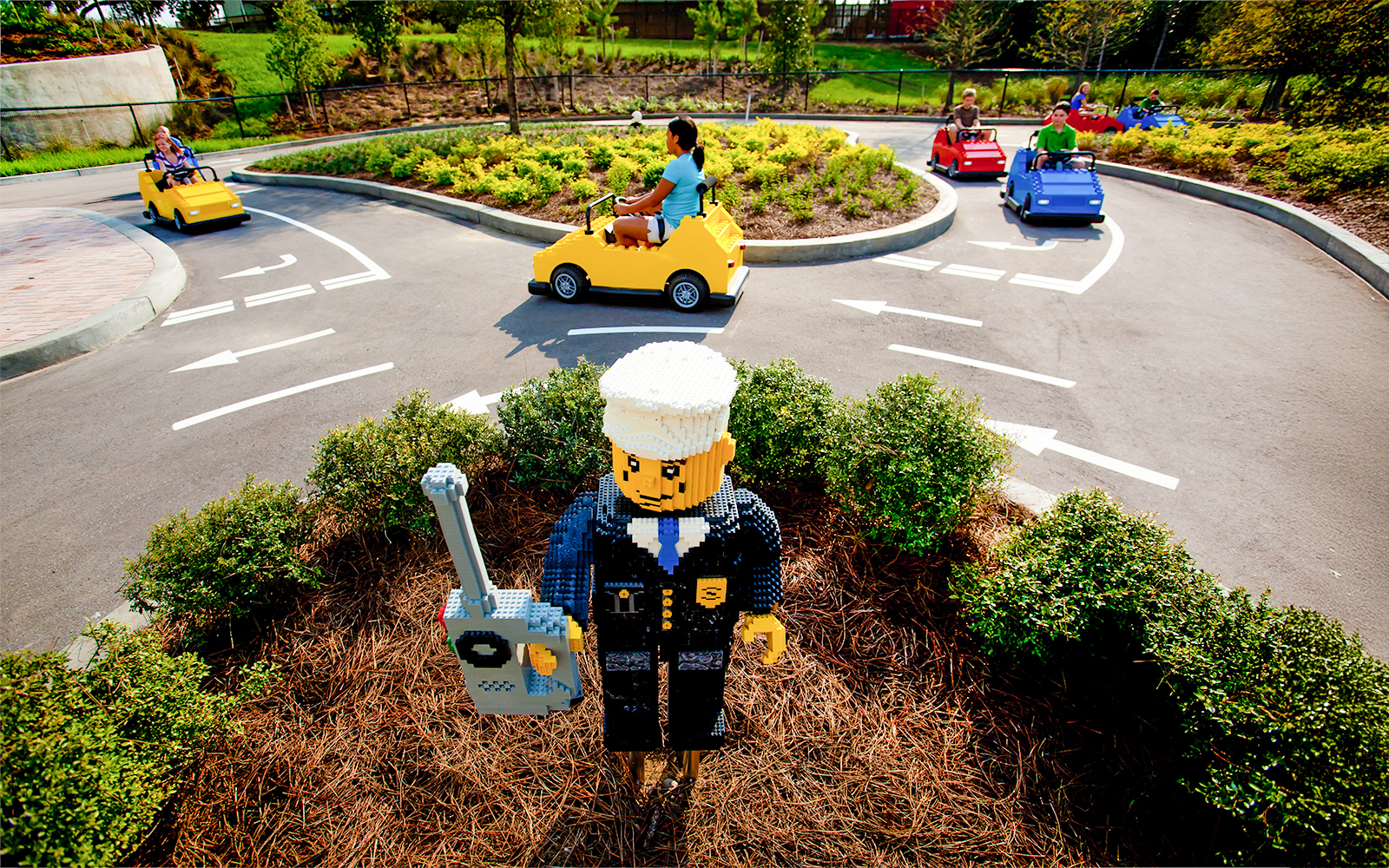 Driving School Ferrari Build and Race Test Zone at LEGOLAND Florida with kids in LEGO cars.