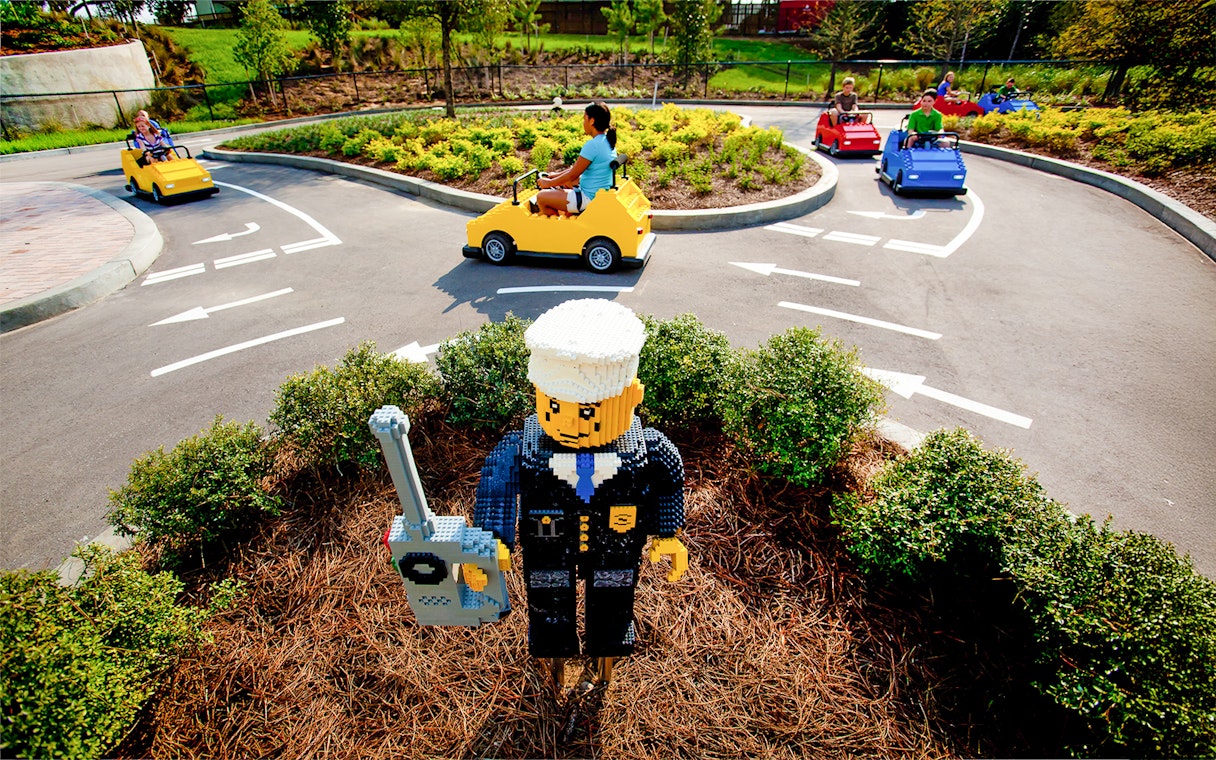 Driving School Ferrari Build and Race Test Zone at LEGOLAND Florida with kids in LEGO cars.