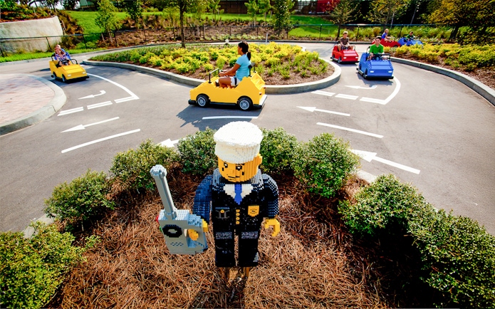 Driving School Ferrari Build and Race Test Zone at LEGOLAND Florida with kids in LEGO cars.