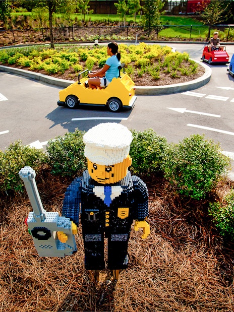 Driving School Ferrari Build and Race Test Zone at LEGOLAND Florida with kids in LEGO cars.