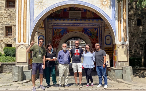 Group of tourists at Rila Monastery entrance, Sofia day trip.