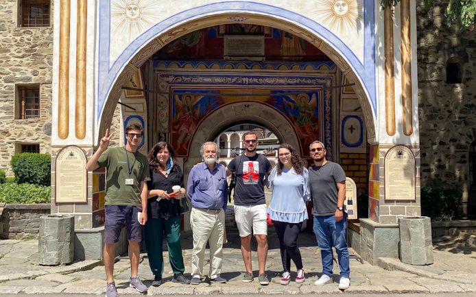 Group of tourists at Rila Monastery entrance, Sofia day trip.