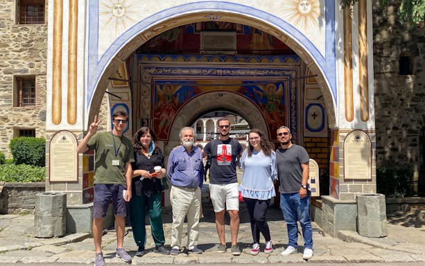 Group of tourists at Rila Monastery entrance, Sofia day trip.