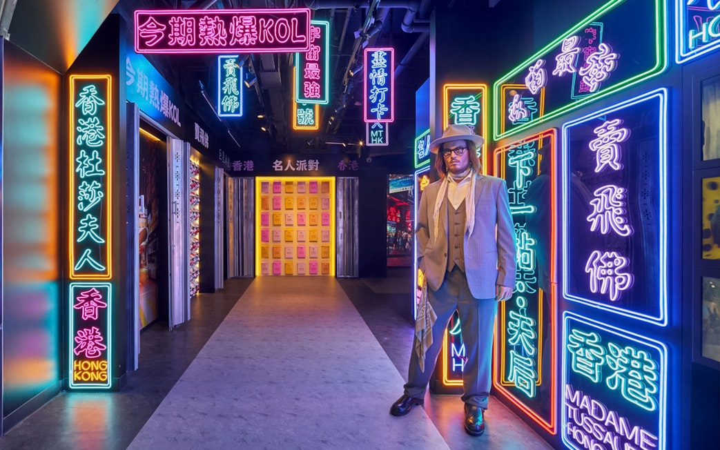 Wax figure in neon-lit corridor at Madame Tussauds Hong Kong.