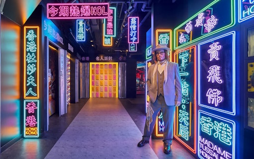 Wax figure in neon-lit corridor at Madame Tussauds Hong Kong.