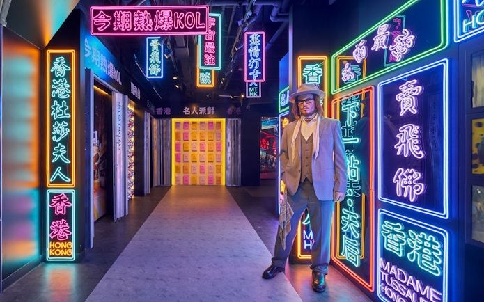 Wax figure in neon-lit corridor at Madame Tussauds Hong Kong.