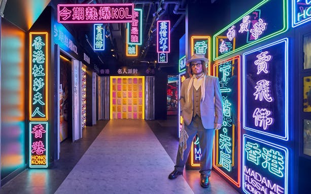 Wax figure in neon-lit corridor at Madame Tussauds Hong Kong.