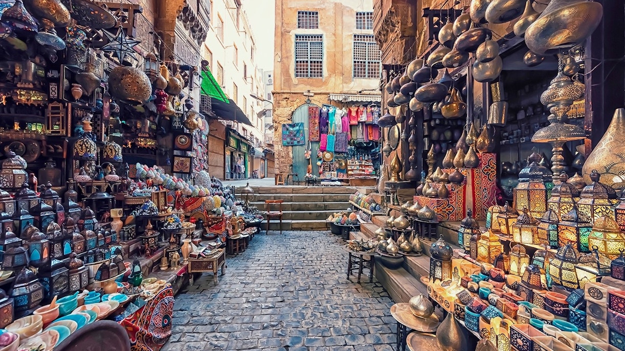 Market stalls with colorful lanterns and pottery at Khan El Khalili Bazaar, Cairo.