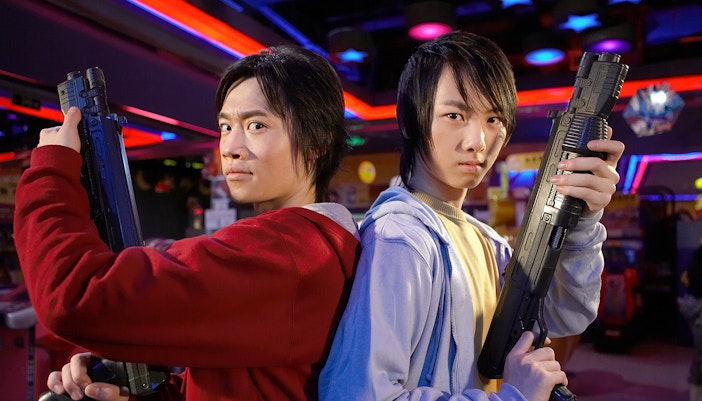 Teens with arcade guns at Tokyo Joypolis