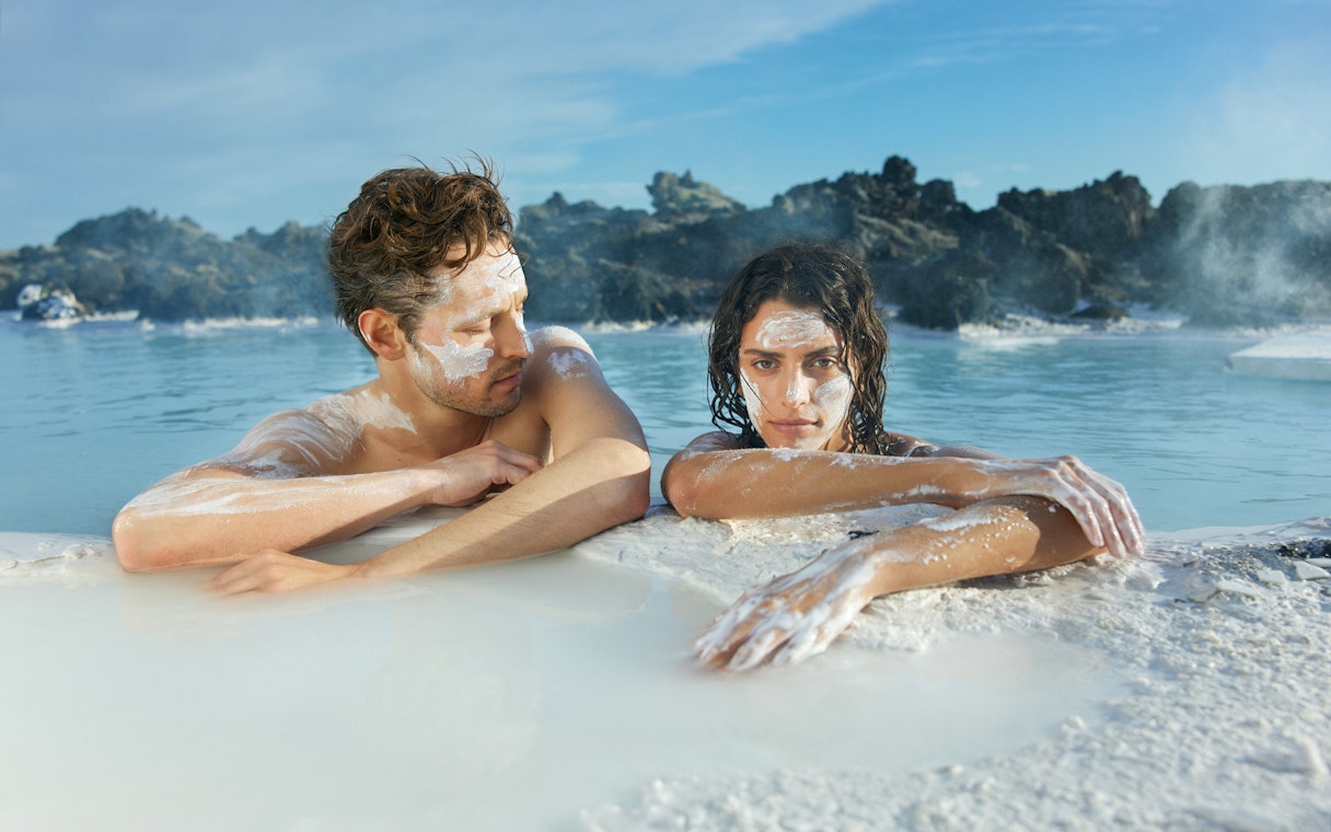 Couple relaxing in geothermal waters at Blue Lagoon, Iceland.