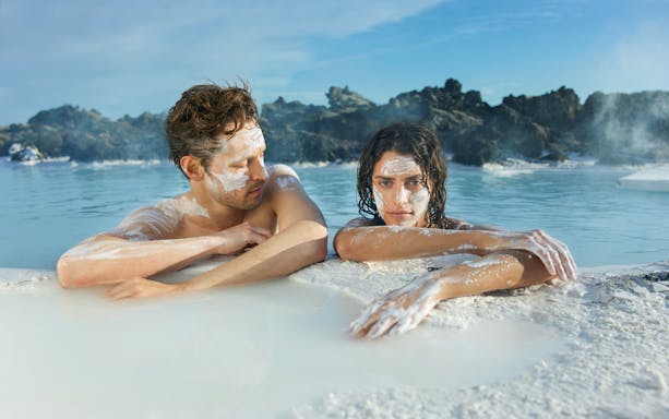 Couple relaxing in geothermal waters at Blue Lagoon, Iceland.