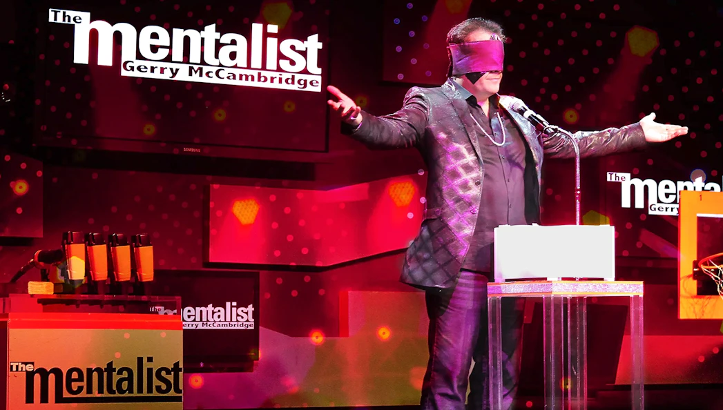 Performer on stage with blindfold during The Mentalist show.