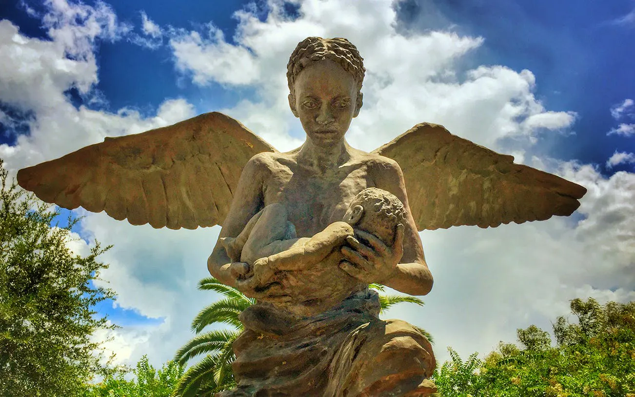 Angel statue holding a child at Whitney Plantation, New Orleans.