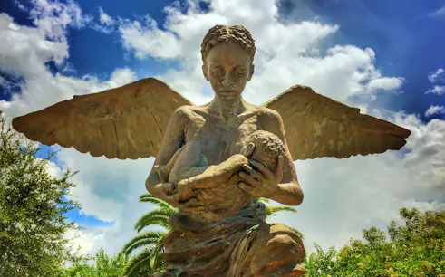 Angel statue holding a child at Whitney Plantation, New Orleans.