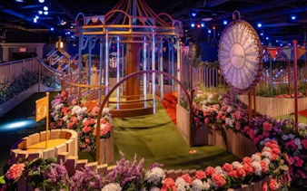 Mini golf course with colorful flowers and carousel at Swingers.