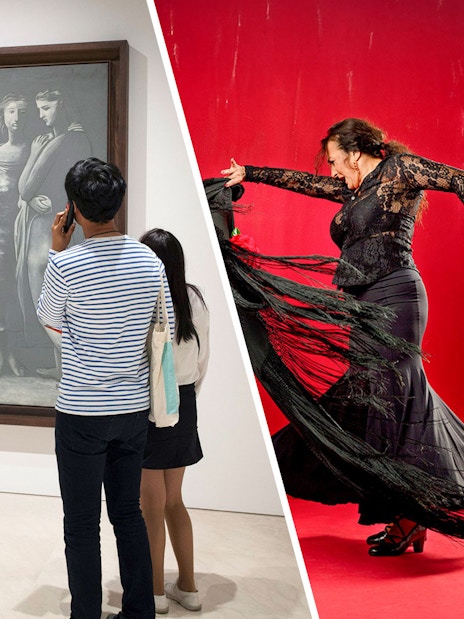 Visitor using audio guide in front of Picasso painting at Picasso Museum Malaga.