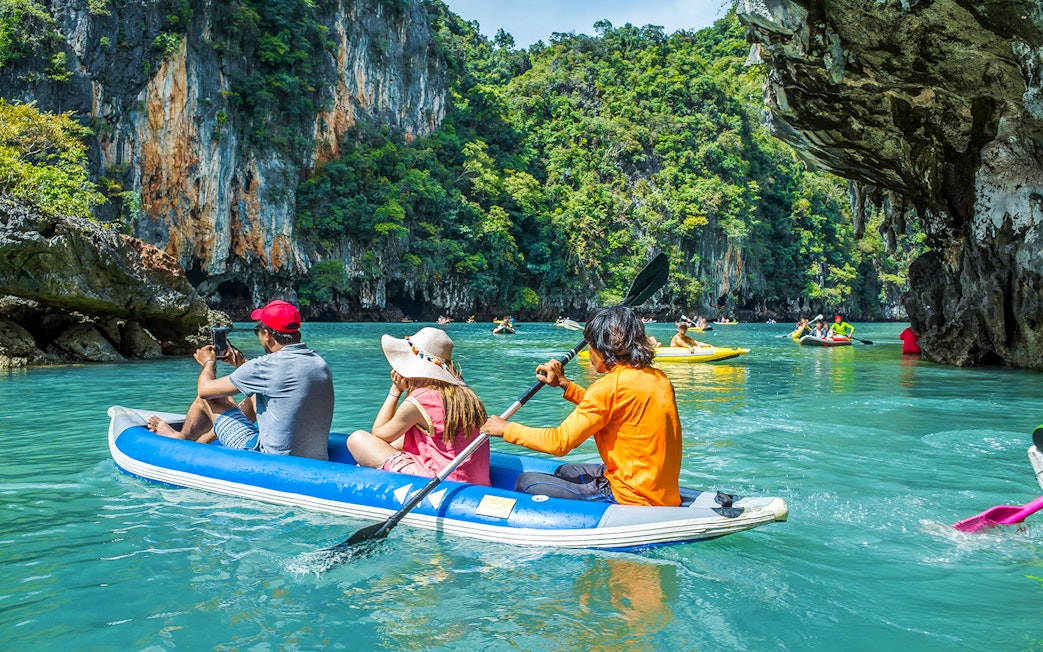 Canoeing through limestone cliffs on Phang Nga Bay during a guided tour to James Bond Island.