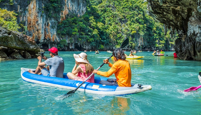 Canoeing through limestone cliffs on Phang Nga Bay during a guided tour to James Bond Island.